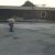 Employee spraying sealer on a parking lot thumbnail