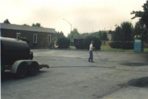 Seal coating in progress on a parking lot